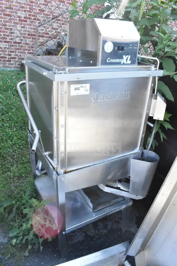 Jackson Conserver XL Pass Through Dishwasher with tables, 115V, 1 phase. Stainless steel, commercial-grade, used condition.