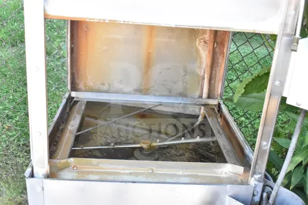 Jackson Conserver XL commercial pass-through dishwasher, visible interior, used condition, includes right-side tables, 115V, 1 phase.
