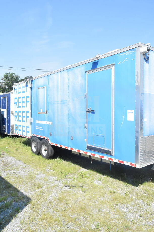 2021 Rock Solid Cargo 8.5'x24' blue food trailer with dual axles and side door, VIN 7H2BE2426MD037994, in good condition.