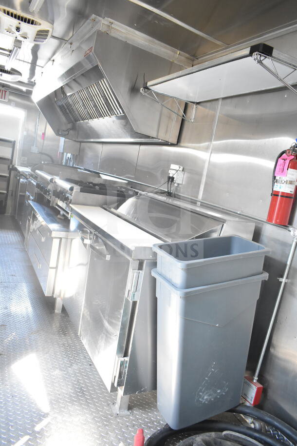 2021 Rock Solid Cargo 8.5'x24' food trailer interior, stainless steel kitchen setup, ventilation hood, fire extinguisher.