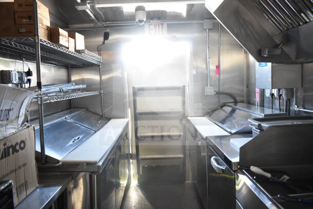 2021 Rock Solid Cargo 8.5'x24' food trailer interior, stainless steel countertops, ventilation hood, shelving.