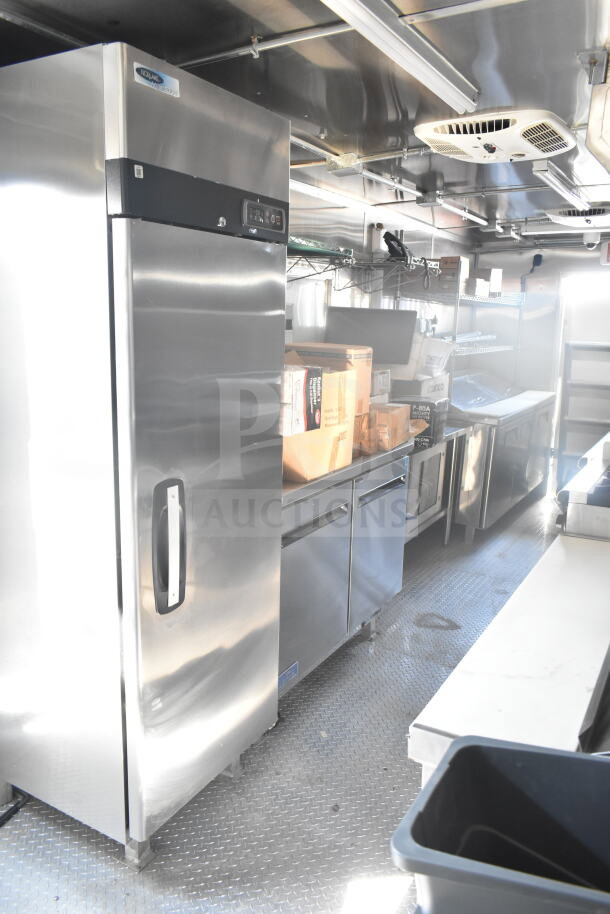 2021 Rock Solid Cargo 8.5'x24' food trailer interior with stainless steel kitchen, large refrigerator, and prep surfaces. VIN 7H2BE2426MD037994.