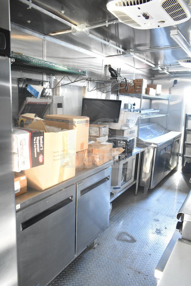 2021 Rock Solid Cargo 8.5'x24' food trailer interior. Features stainless steel counters, shelving, and storage areas. Excellent condition.