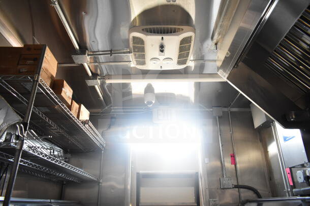 2021 Rock Solid Cargo 8.5'x24' food trailer interior, featuring stainless steel shelves, ventilation, and ceiling equipment.