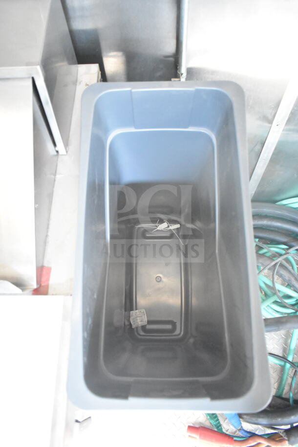 Interior view of 2021 Rock Solid Cargo food trailer showing gray storage bin. Trailer includes CaptiveAire grease hood and refrigeration suite.