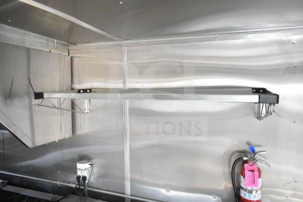 2021 Rock Solid Cargo 8.5'x24' food trailer interior with CaptiveAire grease hood, fire suppression system, stainless steel walls.