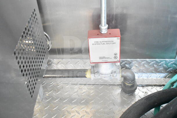 Close-up of a fire suppression system fuel shut-off valve inside a 2021 Rock Solid Cargo 8.5'x24' food trailer.