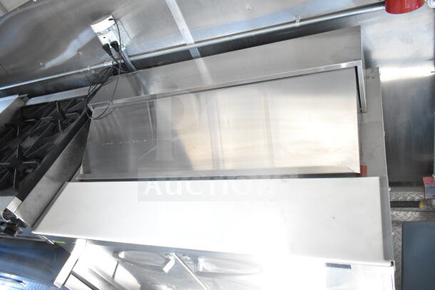 2021 Rock Solid Cargo 8.5'x24' food trailer with CaptiveAire grease hood, equipped kitchen interior, stainless steel surfaces.