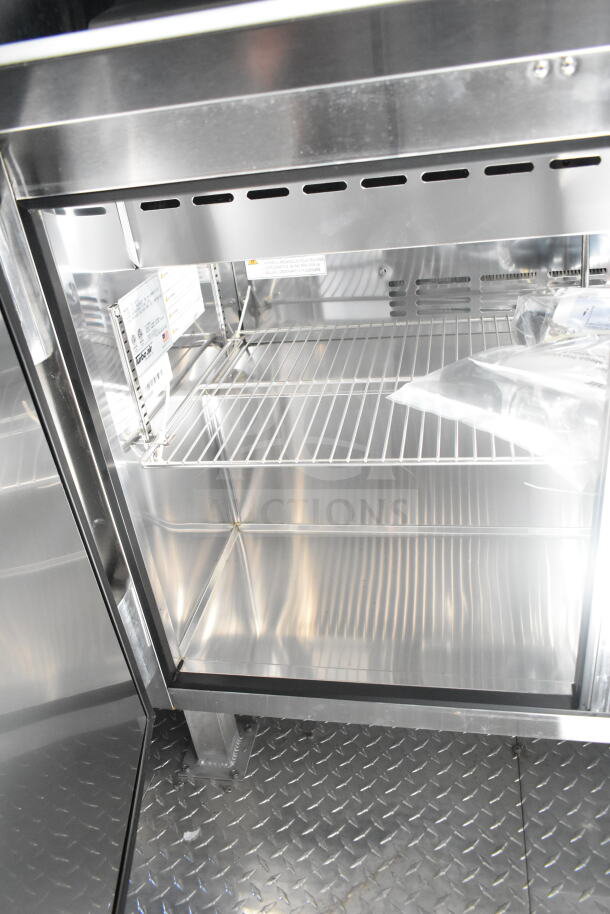2021 Rock Solid Cargo food trailer interior with metal shelving, refrigeration suite, and diamond plate flooring.