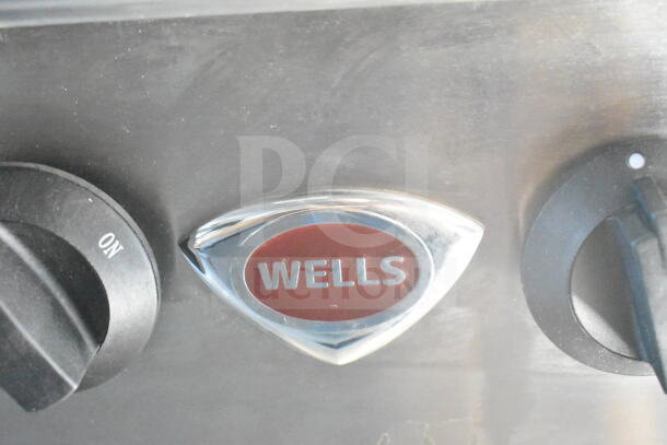 Close-up of a Wells brand control knob on equipment inside a 2021 Rock Solid Cargo 8.5'x24' food trailer.