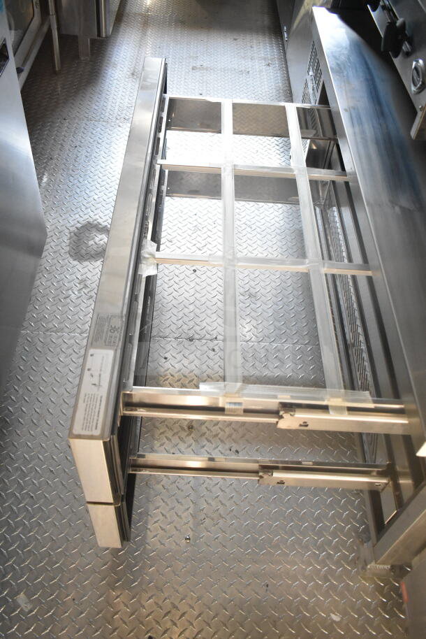 2021 Rock Solid Cargo 8.5'x24' food trailer interior, showing CaptiveAire grease hood and diamond plate flooring.