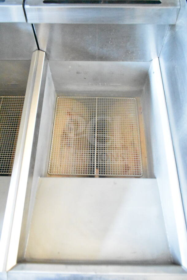 Rock Solid Cargo food trailer interior, featuring Imperial gas fryer with a clean stainless steel design and removable grills.