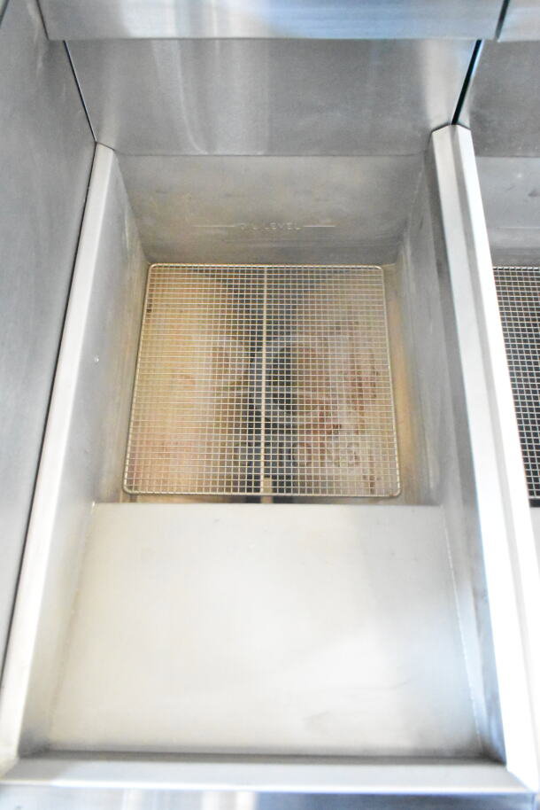 2021 Rock Solid Cargo food trailer interior, featuring Imperial gas fryer with mesh basket, clean stainless steel surfaces.