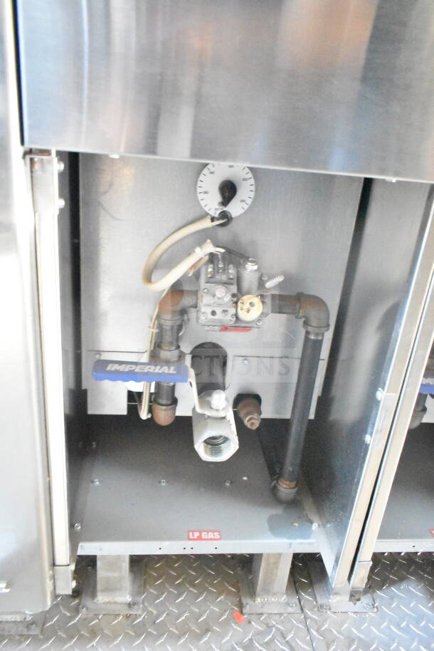 Interior view of 2021 Rock Solid Cargo food trailer showing Imperial gas system with LP gas label, piping, and control dial.