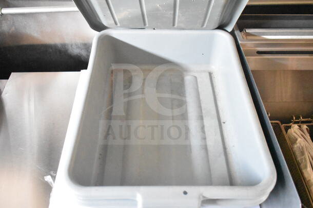 Interior view of a 2021 Rock Solid Cargo 8.5'x24' food trailer, showing a used container inside. Includes CaptiveAire grease hood and fire suppression system.