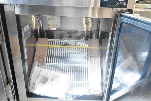 2021 Rock Solid Cargo food trailer with commercial refrigeration suite interiors, new condition, includes manuals and shelving.