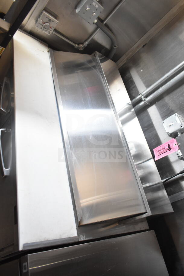 Interior of 2021 Rock Solid Cargo 8.5'x24' food trailer with CaptiveAire grease hood, stainless steel surfaces, and visible fire suppression system.