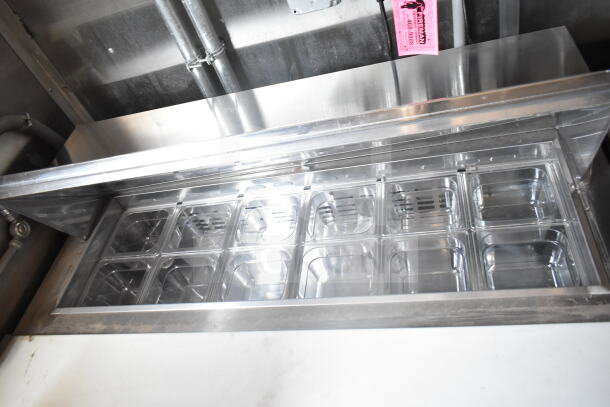 Interior view of a 2021 Rock Solid Cargo food trailer, showcasing a stainless steel food prep area and refrigeration bins.