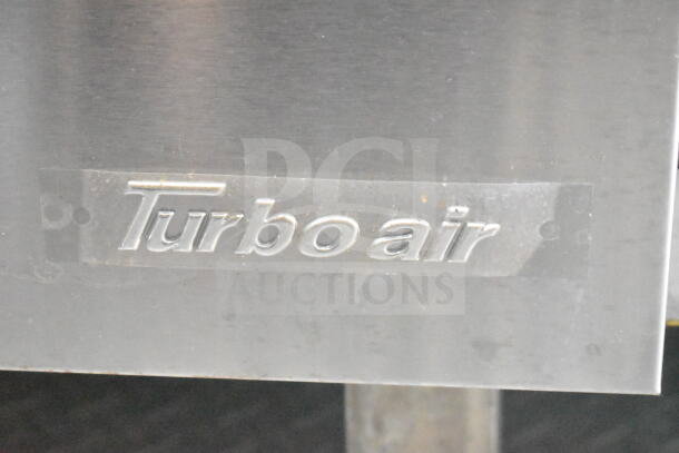 "Turbo Air" logo on stainless steel surface, part of refrigeration suite in 2021 Rock Solid Cargo 8.5'x24' food trailer.