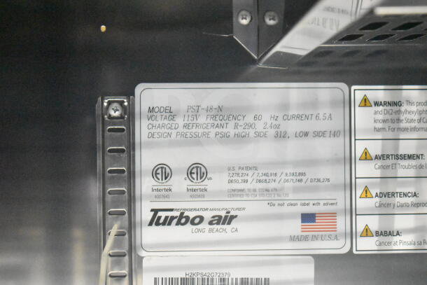 Close-up of Turbo Air label on the 2021 Rock Solid Cargo food trailer, model PST-48-N, with refrigerant and pressure details.