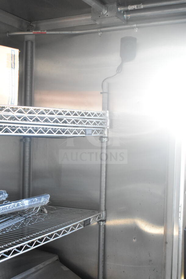 Interior view of 2021 Rock Solid Cargo food trailer showing wire shelving, part of refrigeration suite. Clean condition.