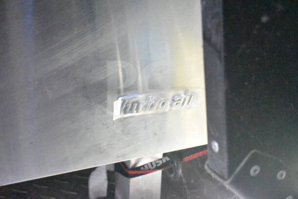 Metallic surface with embossed "Turbo Air" label, part of the 2021 Rock Solid Cargo food trailer's refrigeration suite.