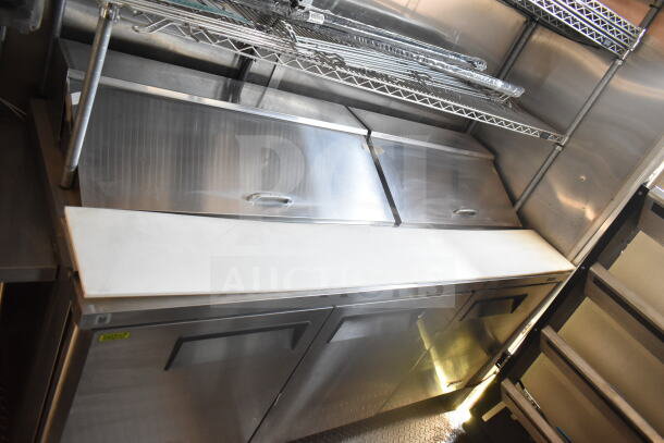 2021 Rock Solid Cargo 8.5'x24' food trailer interior with stainless steel refrigeration suite; shelving and prep area visible.