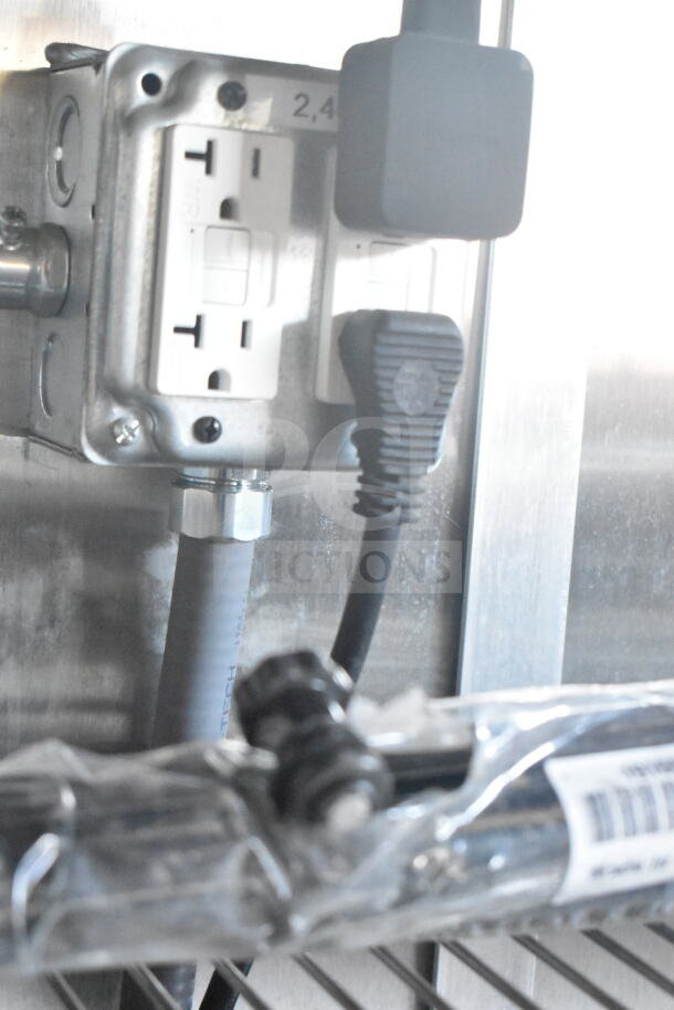 Electrical outlet and wiring inside 2021 Rock Solid Cargo 8.5'x24' food trailer, featuring CaptiveAire grease hood system.