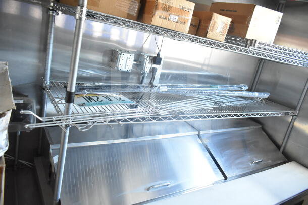 Interior of 2021 Rock Solid Cargo 8.5'x24' food trailer, featuring metal shelving and storage, good condition.