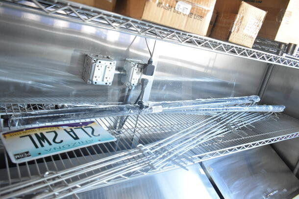 Interior view of 2021 Rock Solid Cargo 8.5'x24' food trailer, showing metal shelving, electrical outlets, and Arizona license plate.
