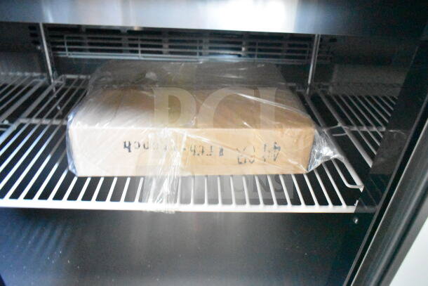 2021 Rock Solid Cargo 8.5'x24' food trailer interior showing refrigeration shelving with packaged contents.