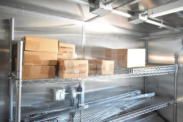 Inside view of 2021 Rock Solid Cargo food trailer featuring metal shelving with stacked boxes. Clean, organized condition.