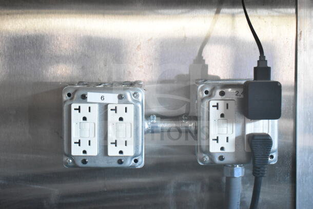 Electrical outlets inside a 2021 Rock Solid Cargo 8.5'x24' food trailer. Visible wiring and labeled panels.