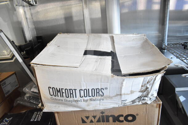 Open Comfort Colors box inside food trailer, showcasing storage shelving. Box is slightly damaged.