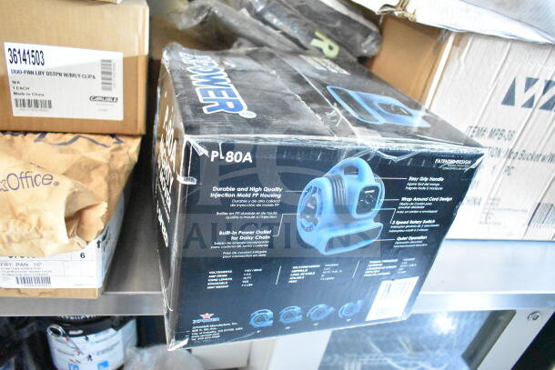 Box of XPower P-80A air mover, featuring durable PP housing and built-in power outlet, shown among other items.