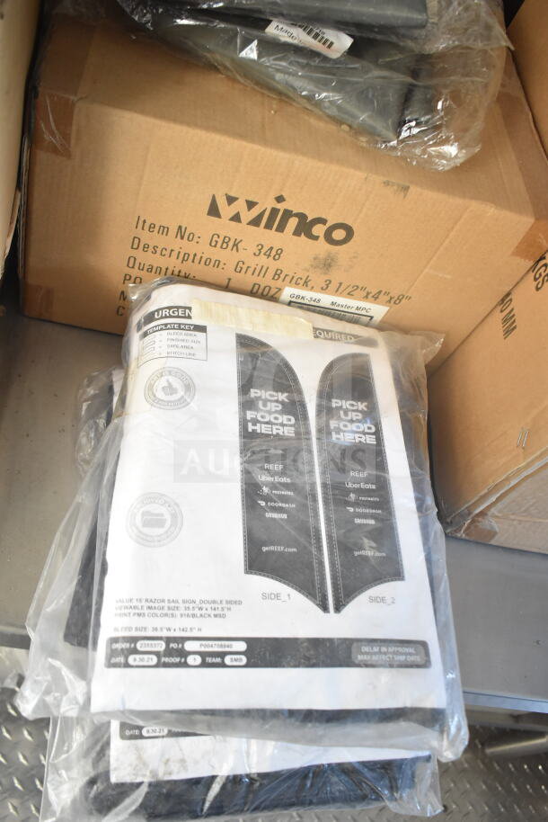 Clear plastic package containing double-sided signs labeled "Pick Up Food Here" for delivery services.