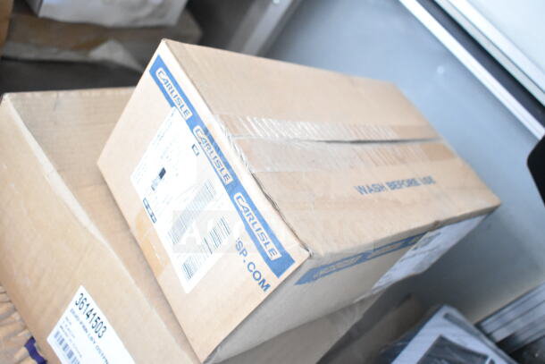 Cardboard box labeled "Carlisle" on a stack, featuring packing and shipping labels.