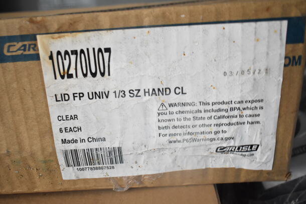 Cardboard box labeled "Carlisle," with a warning about BPA exposure. Label states "Lid FP Univ 1/3 Sz Hand Cl, Clear, Made in China."