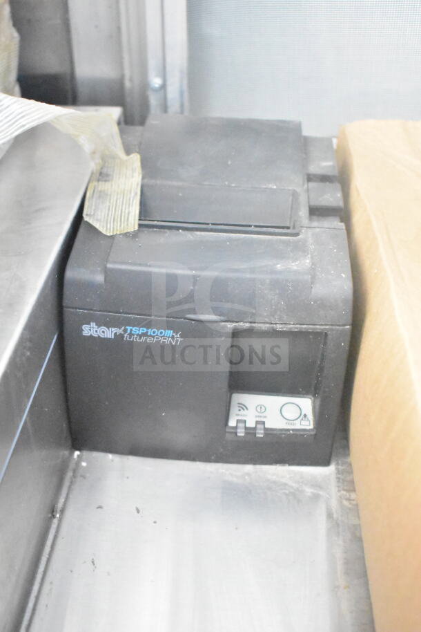 Star TSP100III futurePRNT thermal receipt printer, black, shown in a food trailer. Features ready, error, and feed indicators.