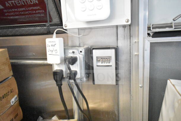 Interior of 2021 Rock Solid Cargo 8.5'x24' food trailer showing electrical outlets. Sign reads "Do Not Unplug."