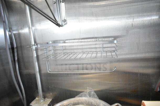 Stainless steel shelf in 2021 Rock Solid Cargo 8.5'x24' food trailer interior. Features integrated CaptiveAire grease hood.