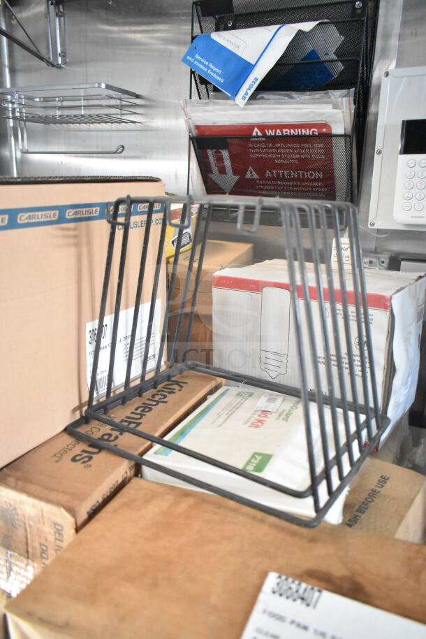 Interior of 2021 Rock Solid Cargo food trailer featuring storage boxes, Carlisle brand packaging, and a metal organizer.