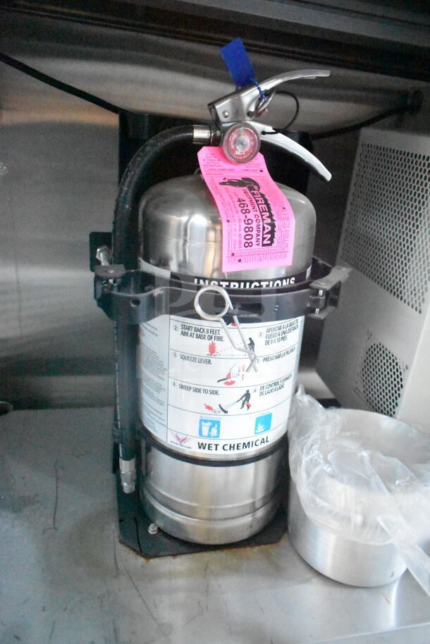 Wet chemical fire extinguisher inside 2021 Rock Solid Cargo 8.5'x24' food trailer, CaptiveAire grease hood, fire suppression system.
