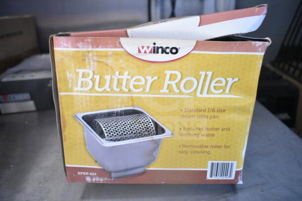Winco Butter Roller in original packaging, model SPBR-604. Features standard 1/6 size steam table pan. Box shows minor wear.