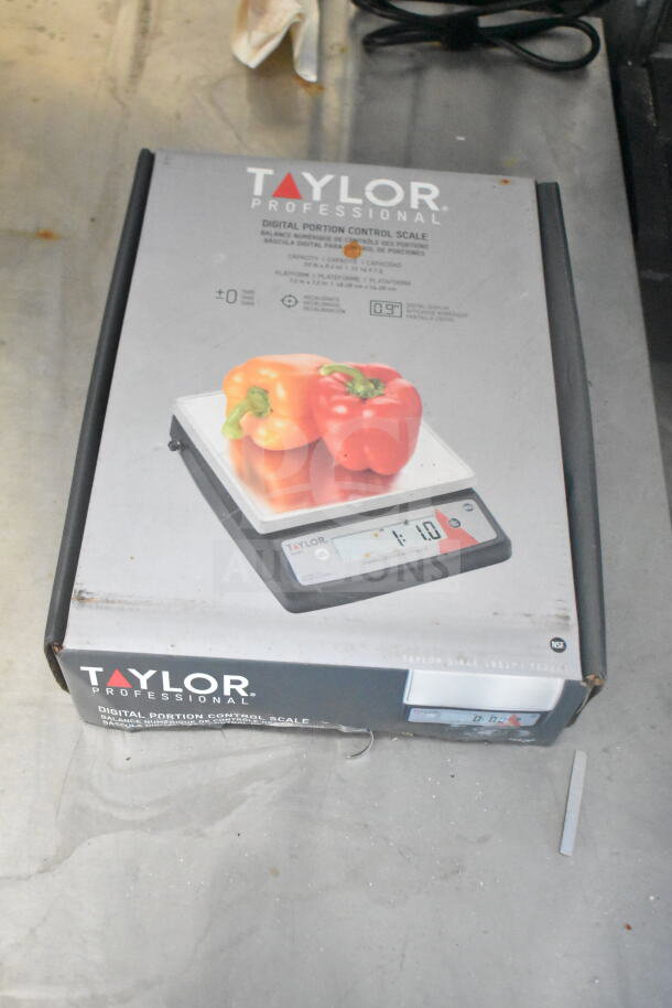 Boxed Taylor Professional Digital Portion Control Scale, featuring a capacity of 11lb. Image shows packaging with product details.