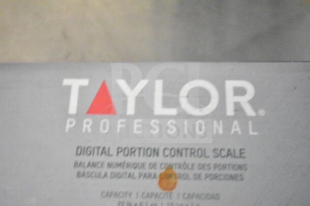 Close-up of a Taylor Professional Digital Portion Control Scale label, showing brand name and multilingual capacity details.