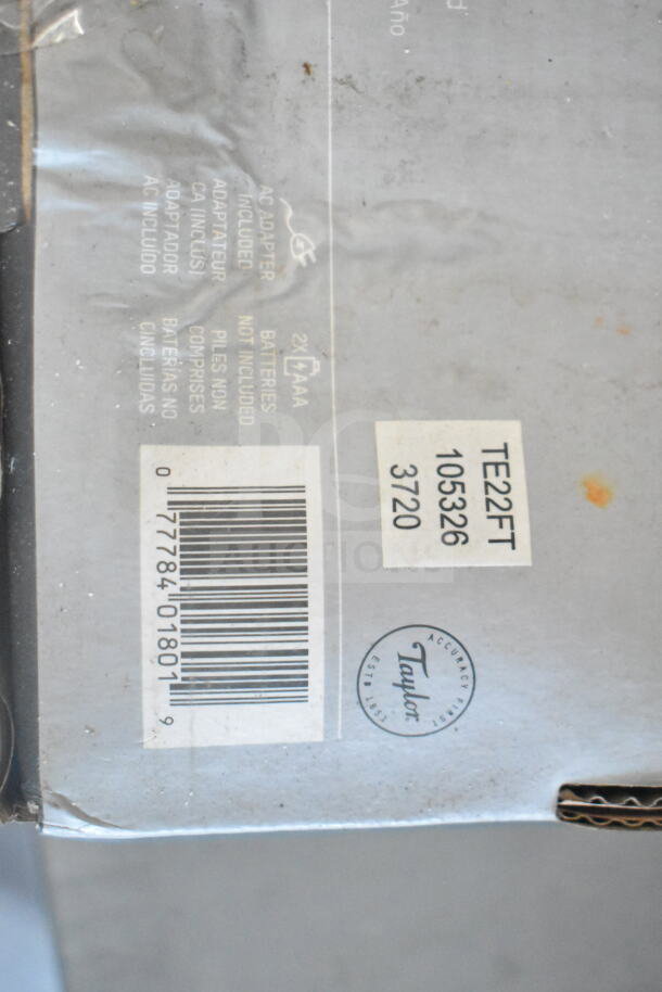 Barcode and labels on packaging, including text indicating an AC adapter and two AAA batteries not included.