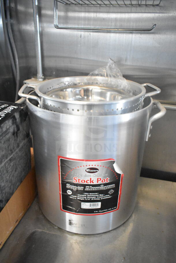 Aluminum stock pot with perforated insert inside a 2021 Rock Solid Cargo 8.5'x24' food trailer kitchen.