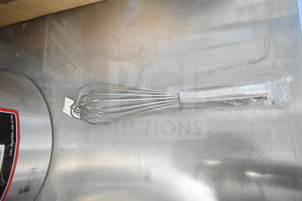 A whisk on a stainless steel surface, partially wrapped in plastic, with a label showing specs from Winco Industries.