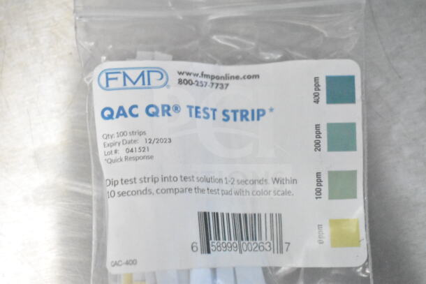 Close-up of FMP QAC QR Test Strip package, showing color scale, lot number 041521, expiry 12/2023, and barcode.